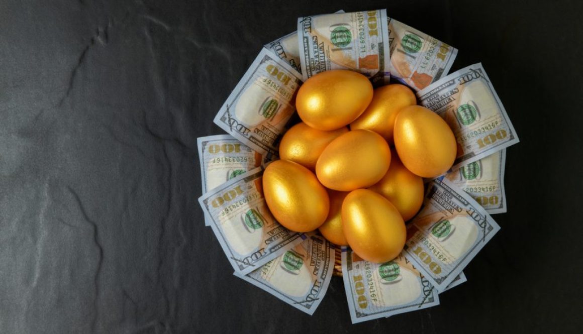 golden eggs and dollars in a basket on black, top view